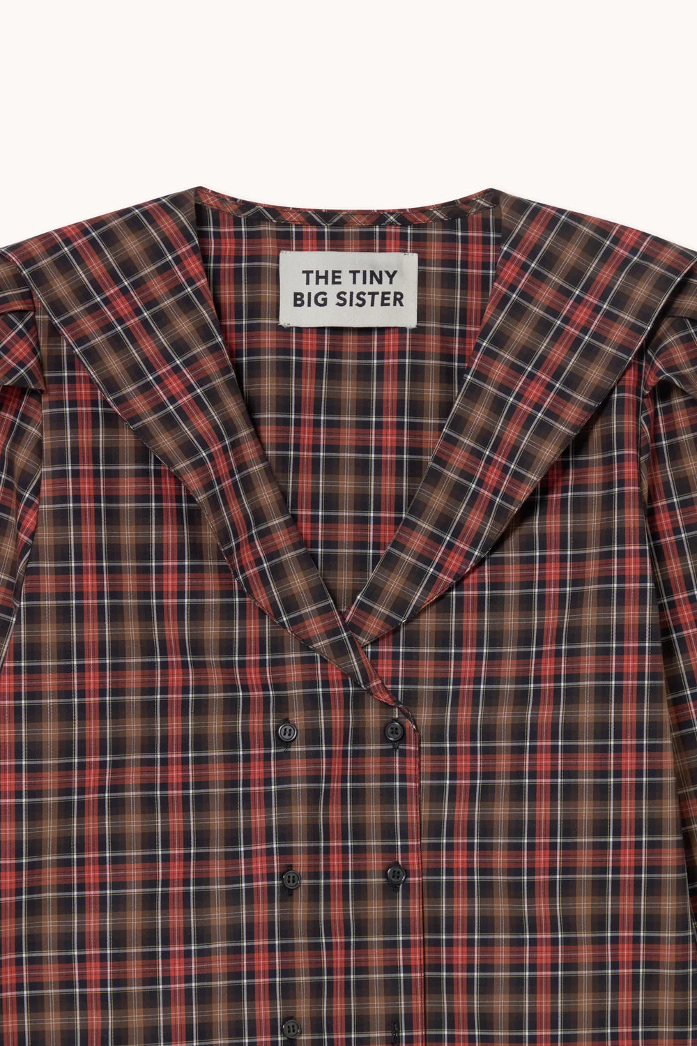 Blouse à carreaux rouge et marron